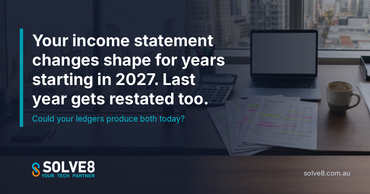 An accounts desk in an Australian office with printed income statements, a calculator and a laptop: every ledger account mapped to the new AASB 18 income statement categories before the first close