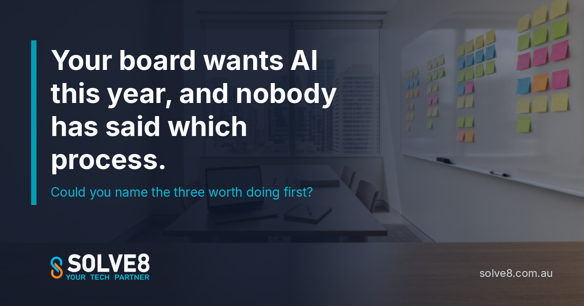 An Australian office meeting room with a whiteboard covered in sticky notes and a laptop on the table: choosing which three processes to automate first